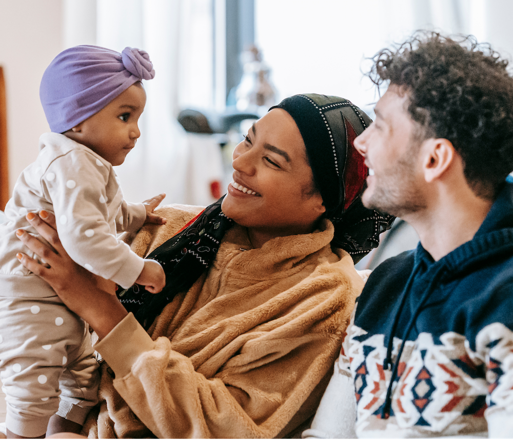 A family holds their newborn baby.